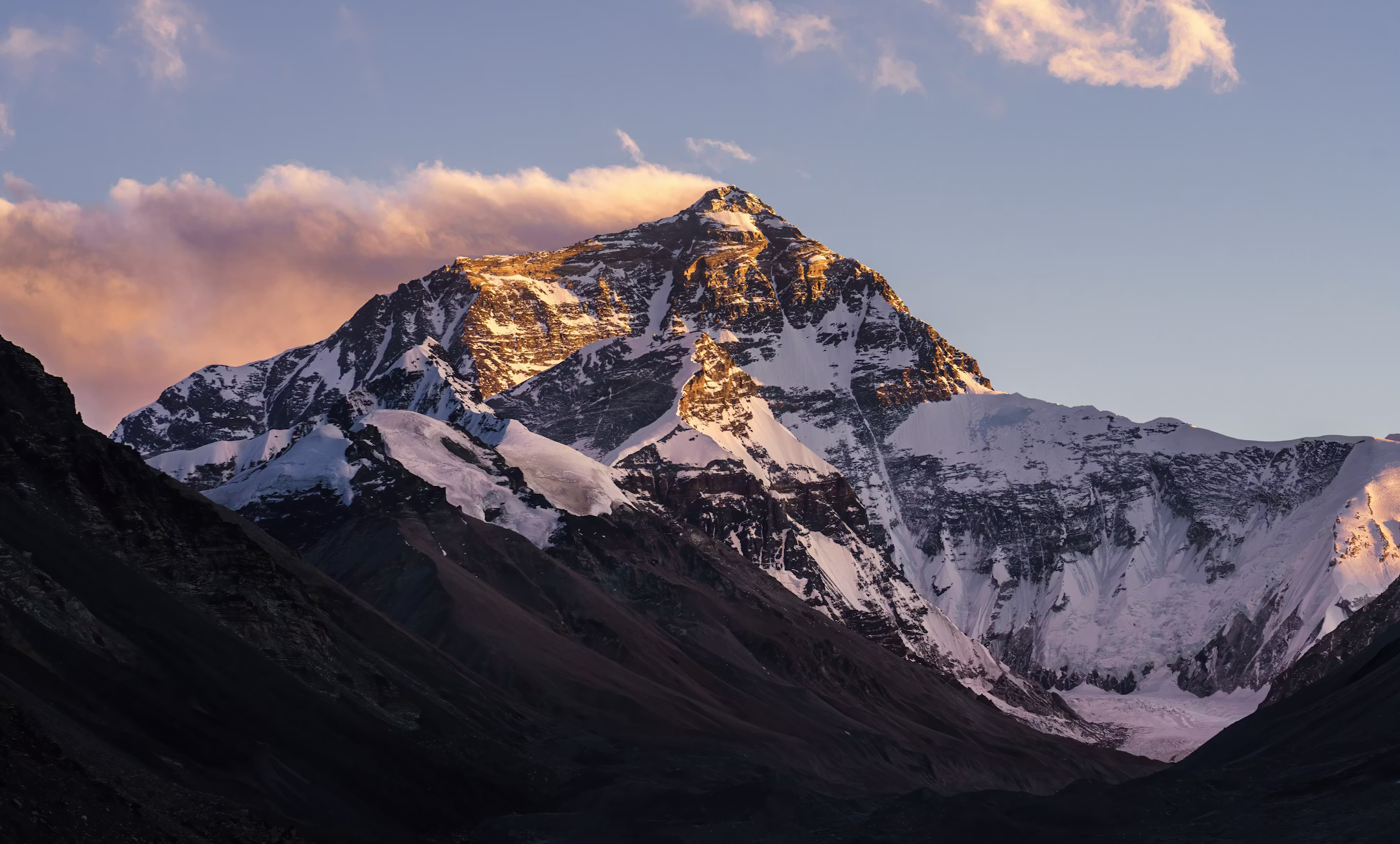 Sunlit Himalayan peaks rising above the clouds in Nepal